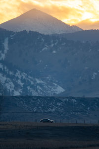 Scenic view of snowcapped mountains against sky during sunset