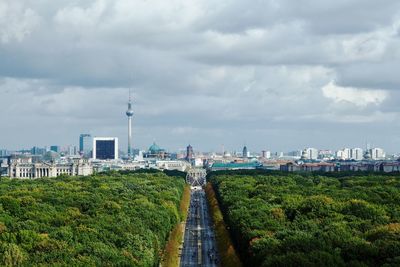 View of cityscape against cloudy sky