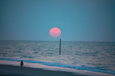 People walking at sunrise on topsail island