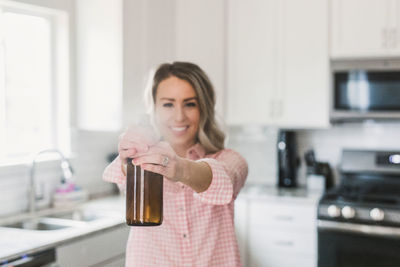 Portrait of a smiling young woman at home