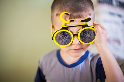 Portrait of cute boy wearing novelty glasses