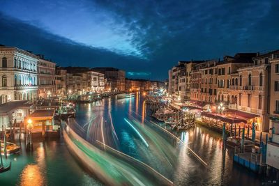 Canal passing through city at night