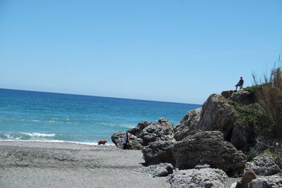 Scenic view of sea against clear blue sky