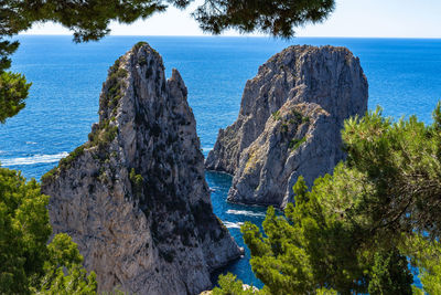 View of faraglioni, three majestic rocks that emerge from the sea, the most iconic sight of capri