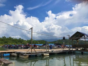 Boats moored in water against sky