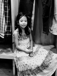 Portrait of girl sitting at shop