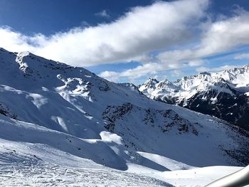 Scenic view of snowcapped mountains against sky