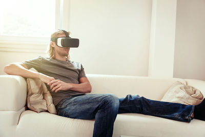 Man sitting on sofa at home