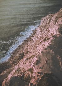 High angle view of sea by cliff