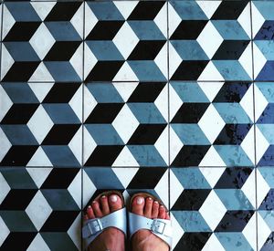 Low section of woman standing on tiled floor