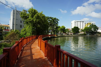 Canal amidst buildings against sky