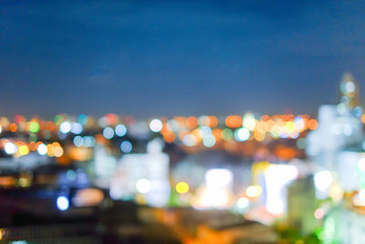 Defocused image of illuminated city at night