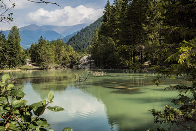 Scenic view of lake and mountains against sky