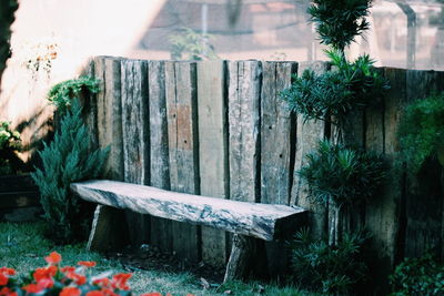 Empty seat by wooden fence