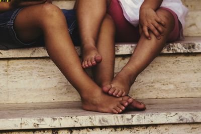 Low section of friends sitting outdoors