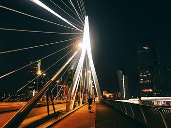 Low angle view of illuminated bridge against sky at night