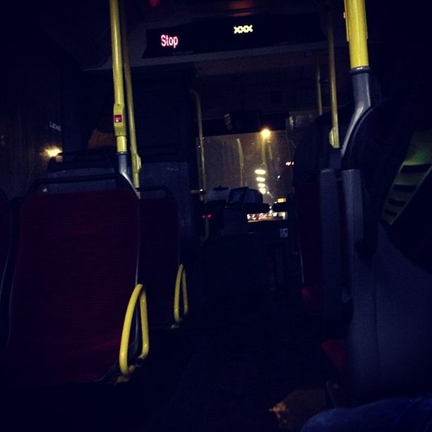 indoors, illuminated, transportation, night, absence, empty, in a row, dark, mode of transport, land vehicle, car, built structure, chair, seat, no people, the way forward, architecture, bus, lighting equipment, incidental people