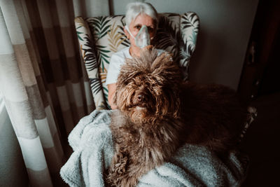 Portrait of woman with dog at home