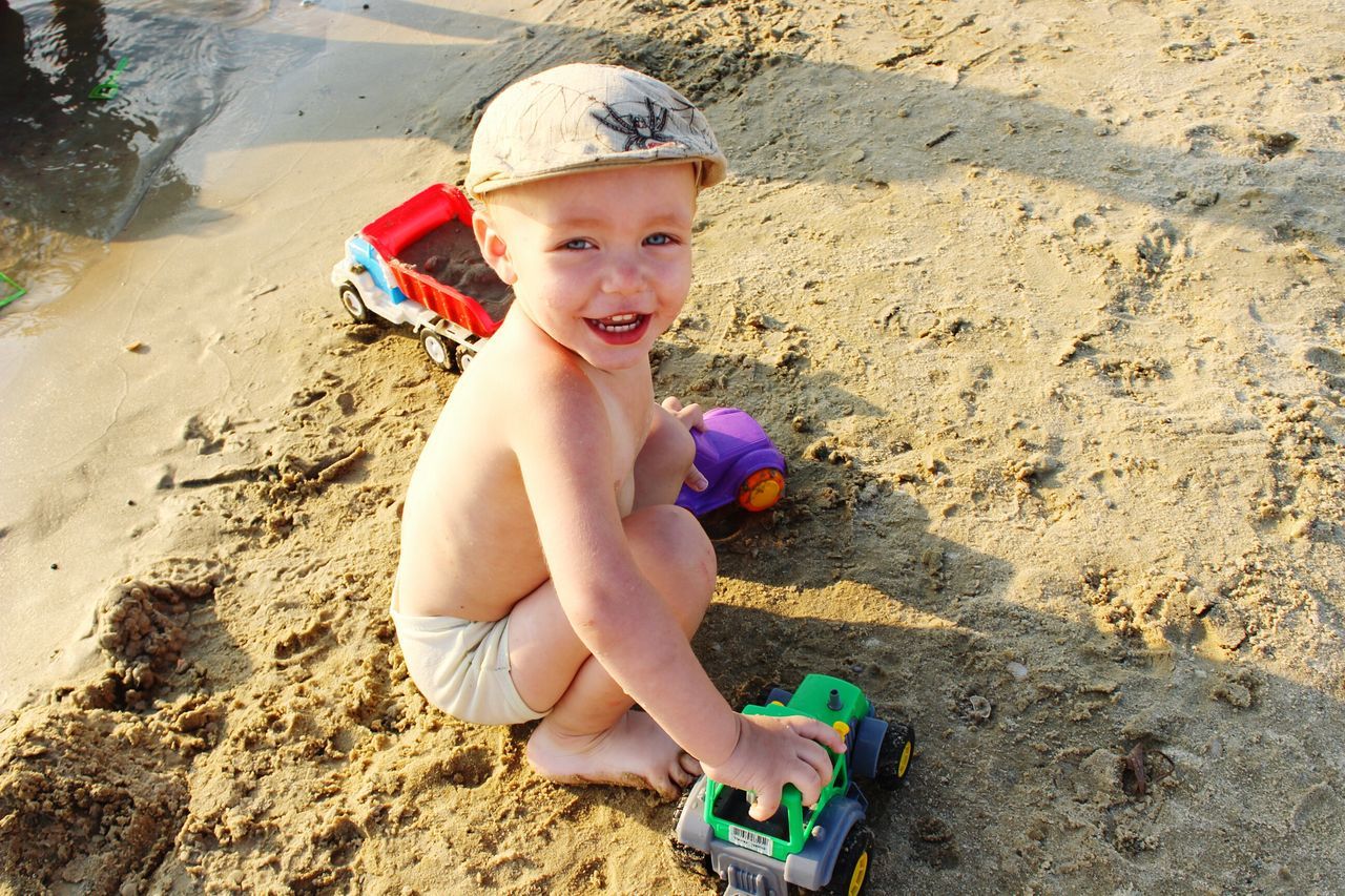 childhood, person, elementary age, sand, beach, lifestyles, innocence, cute, girls, leisure activity, portrait, boys, full length, happiness, looking at camera, smiling, casual clothing, playful