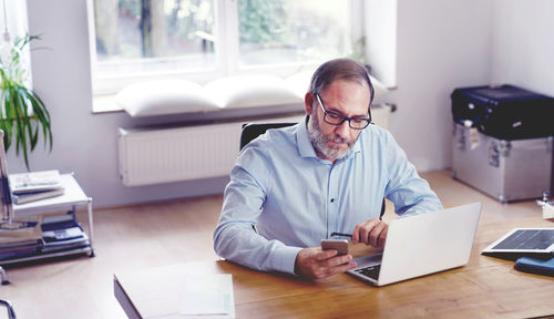 Man using laptop on table