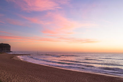 Scenic view of beach against sky during sunset