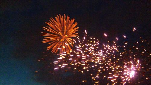 Low angle view of firework display at night