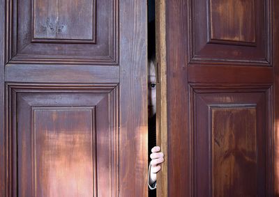 Portrait of boy peeping from door