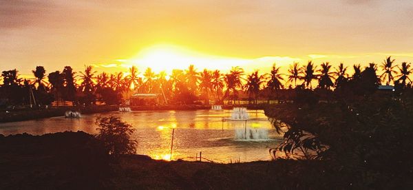 Scenic view of lake against orange sky