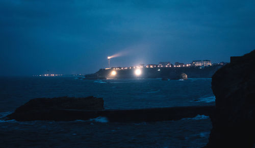 Scenic view of sea against blue sky at night