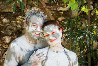 Portrait of smiling man and woman with facial mask on face