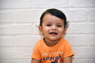 Portrait of cute boy against wall