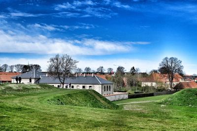 Houses on field against sky