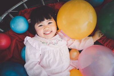 Portrait of cute girl with balloons