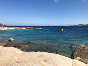 Scenic view of sea against clear blue sky