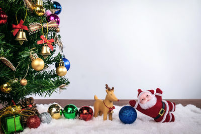 Close-up of christmas decorations against white background