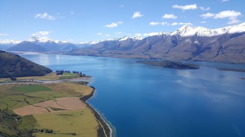 Scenic view of lake and mountains against sky