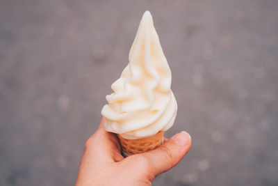 Close-up of hand holding ice cream cone