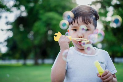Portrait of boy holding bubbles