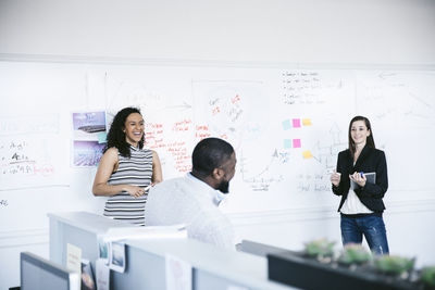 Cheerful business people discussing in meeting at office