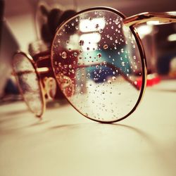 Close-up of water drops on glass table