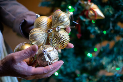 Close-up of hand holding christmas decoration