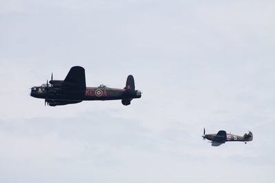 Low angle view of airplane flying against sky