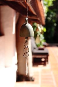 Close-up of metallic bell hanging to roof