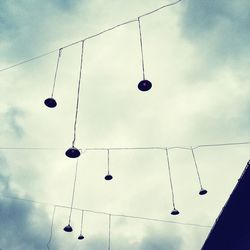 Low angle view of power lines against sky