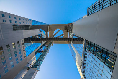 Low angle view of modern building against blue sky