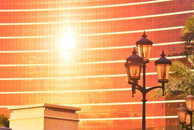 Illuminated street light against brick wall