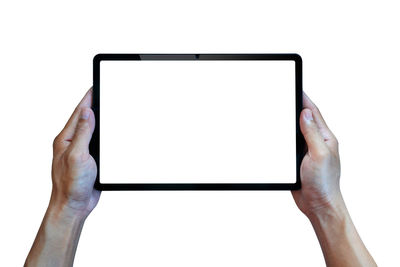 Cropped hands using digital tablet against white background