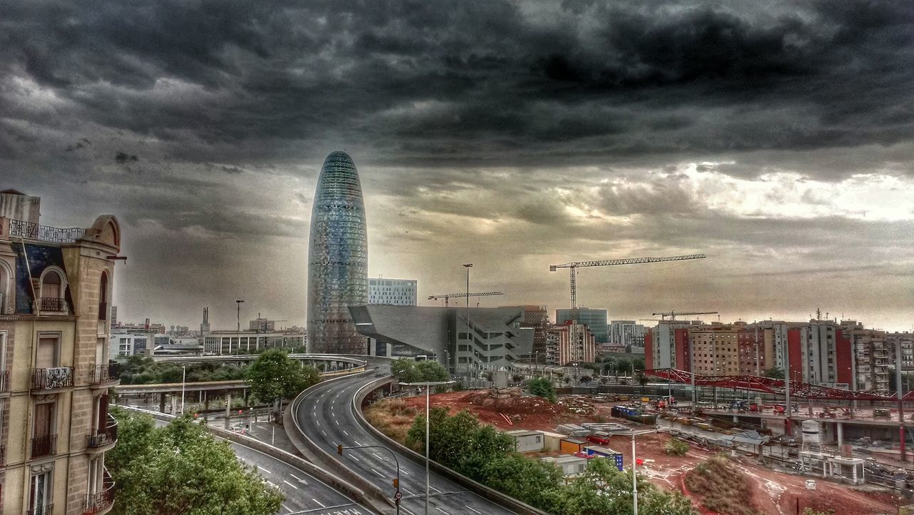 VIEW OF CITYSCAPE AGAINST CLOUDY SKY