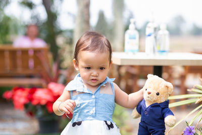 Cute boy with toy against blurred background