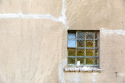 Low angle view of window covered with building